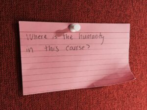 A notecard that reads "Where is the humanity in this course?"