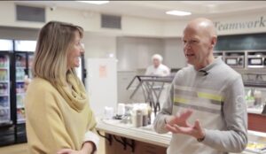 Momentum-builder: a still of the instructor taking the students on a video tour of a facility