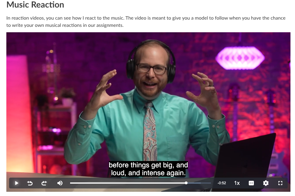 Screenshot of video showing instructor reacting verbally to music and using body language to show the music is loud and intense
